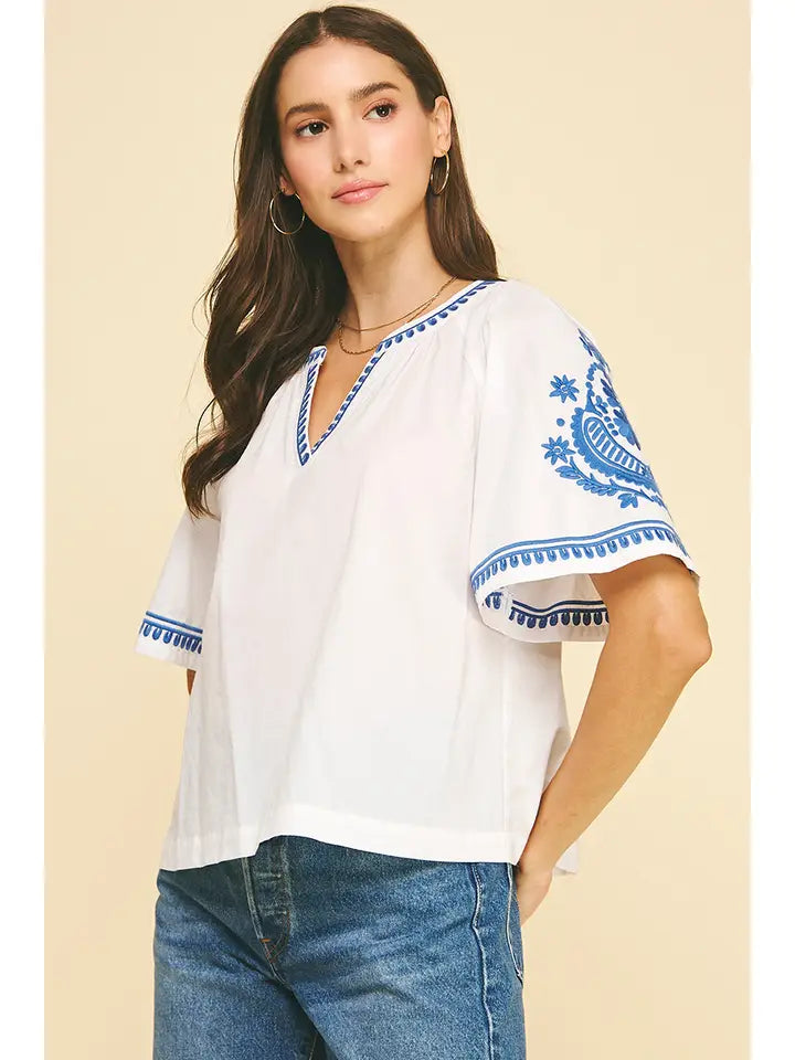 White embroidered blouse with blue stitching